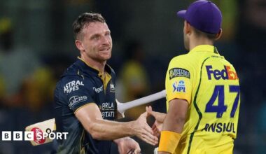 Gujarat Titans' Jos Buttler shakes hands with Chennai Super Kings' Anshul Kamboj after the match