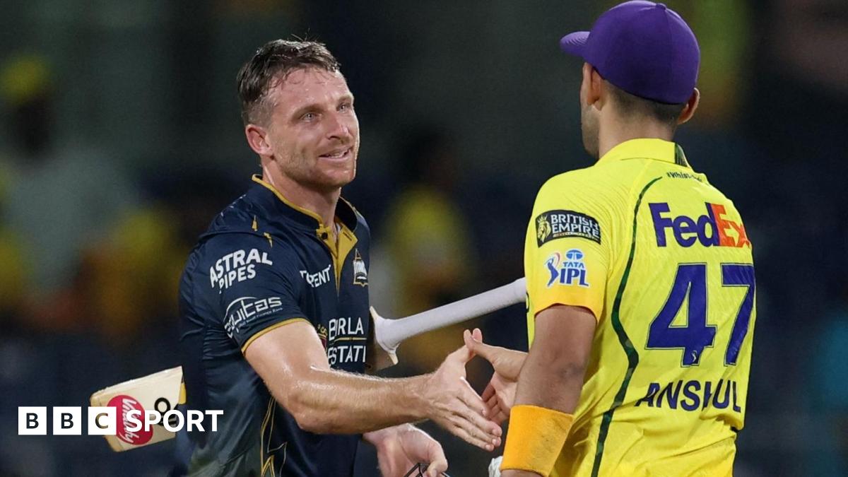 Gujarat Titans' Jos Buttler shakes hands with Chennai Super Kings' Anshul Kamboj after the match