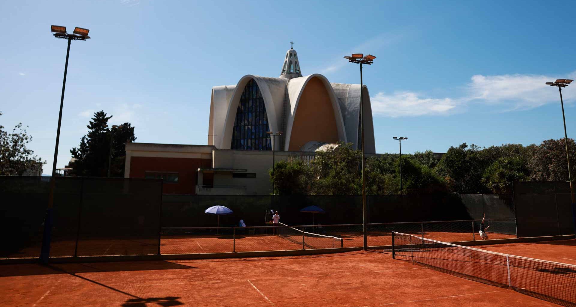The Sardegna Open is played at the Tennis Club Cagliari, with Chiesa dei Santi Giorgio e Caterina in the background.