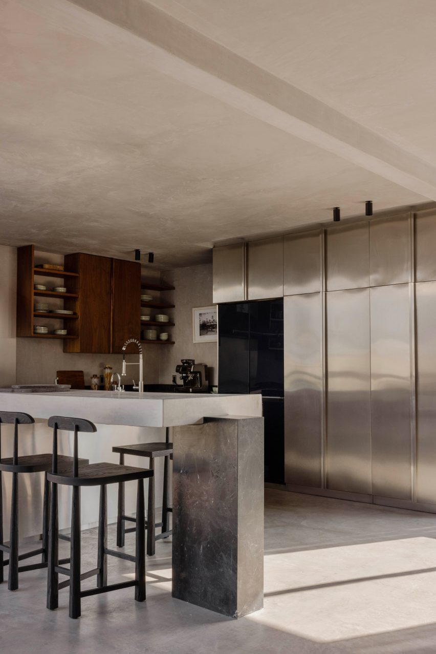 Kitchen with stainless steel storage doors and smaller walnut cabinets