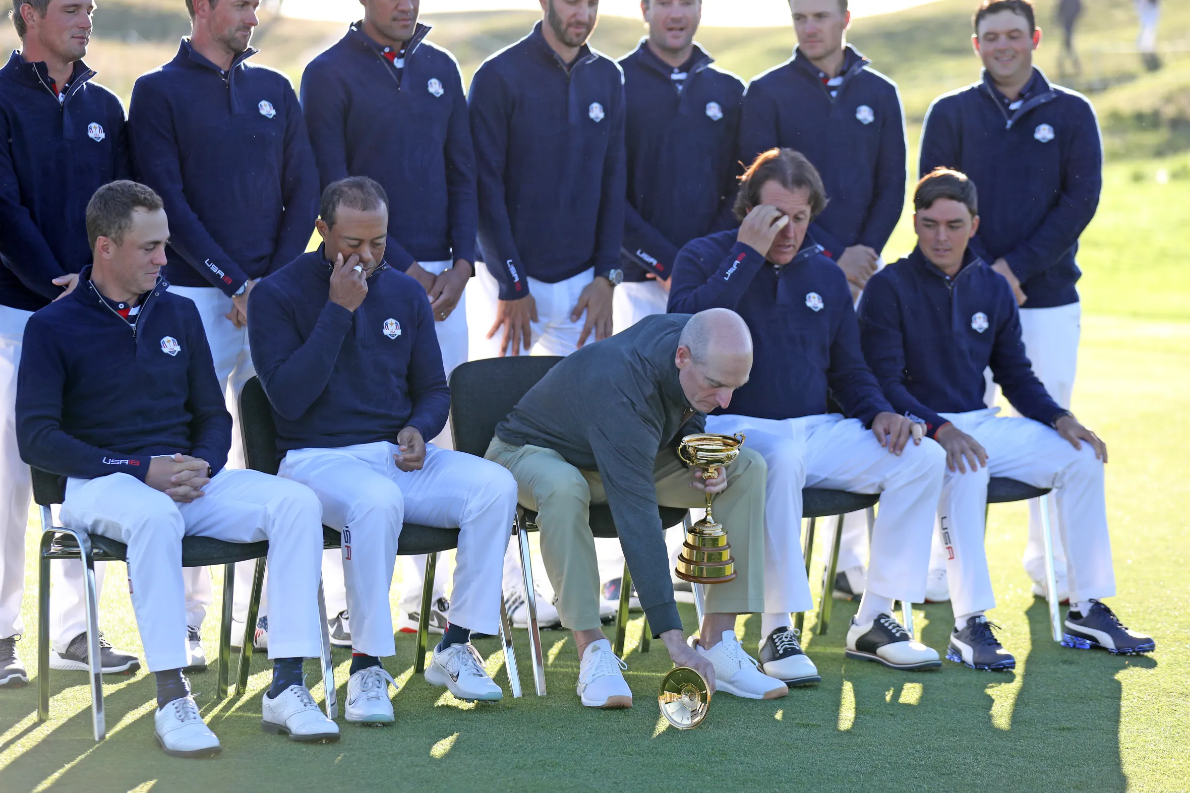 Team captain Jim Furyk dropping the lid from the Ryder Cup trophy during a team photo.