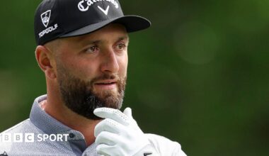 Jon Rahm with his hand on his chin