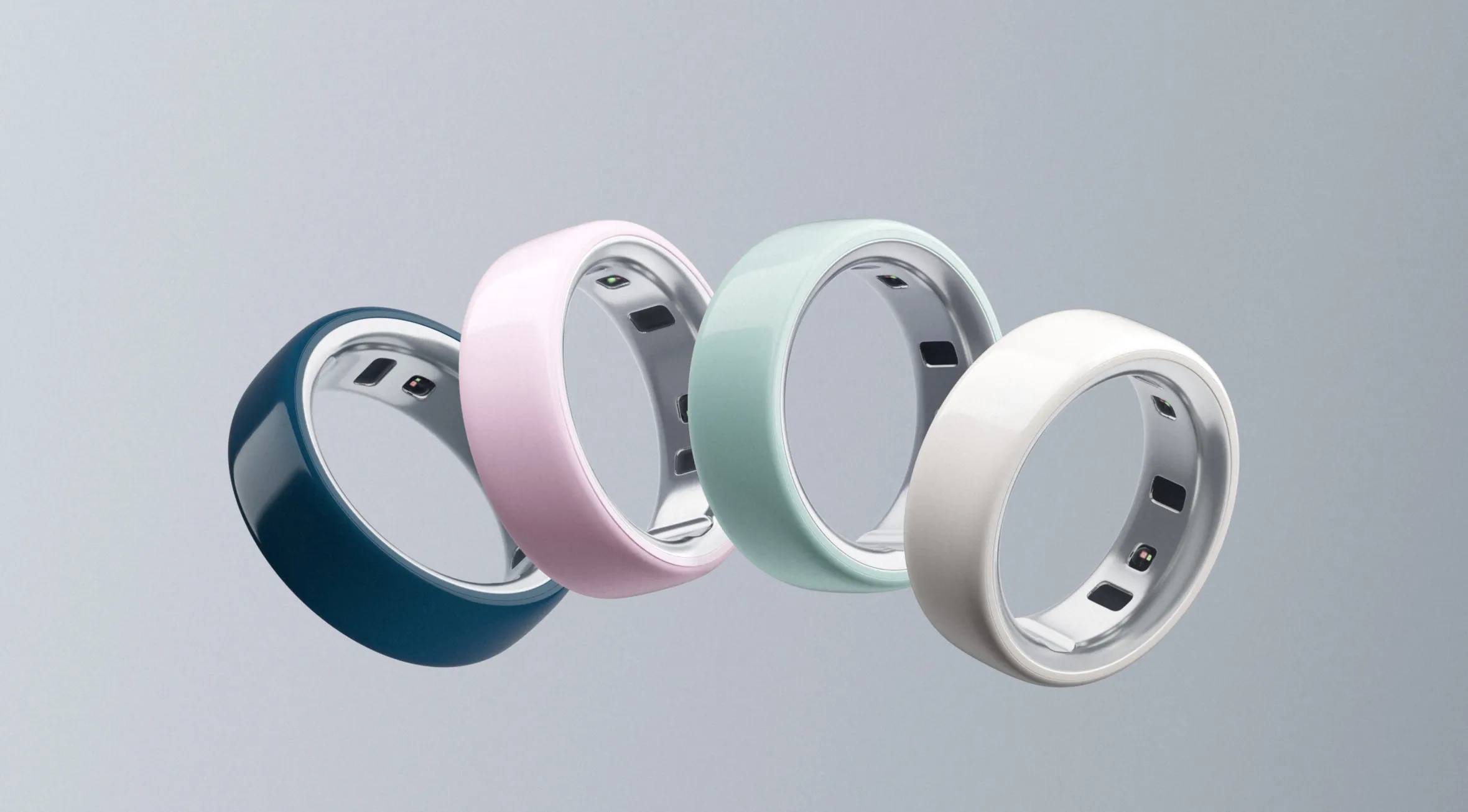 Four Oura Rings in blue, pink, mint green, and white.