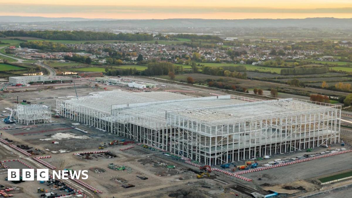 an aerial view of the construction site showing vehicles and concrete piles driven into the ground