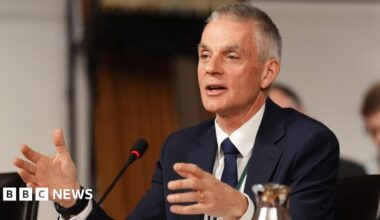 Picture of Tim Davie from March 2026 in a blue suit with a white shirt and a matching tie