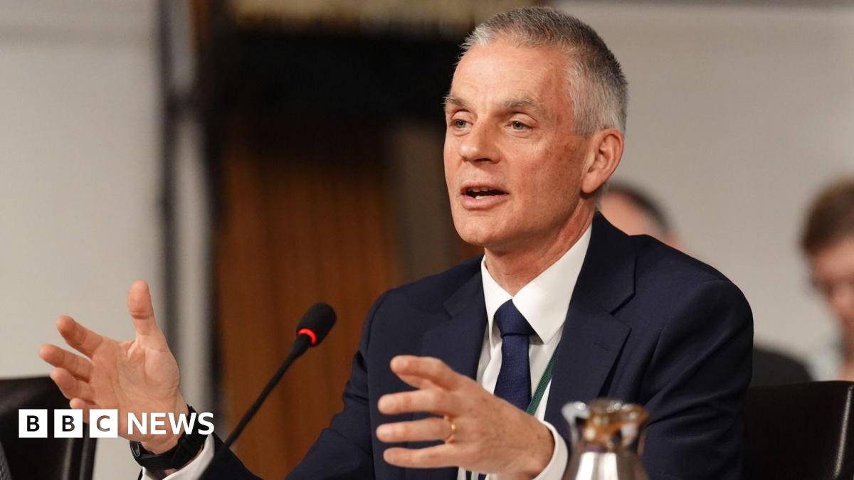 Picture of Tim Davie from March 2026 in a blue suit with a white shirt and a matching tie