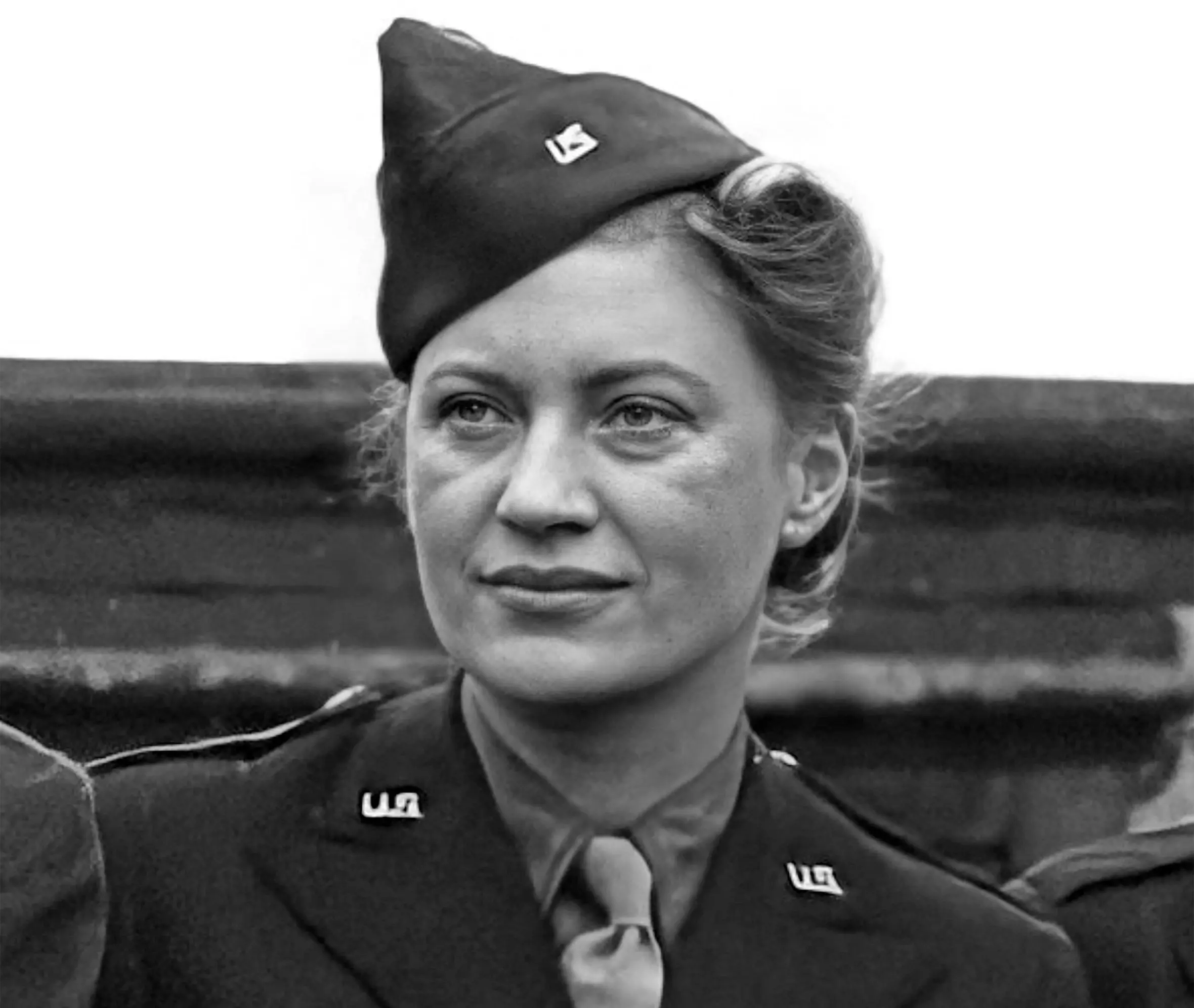 Black and white photo of American photographer and journalist Lee Miller in a US military uniform.