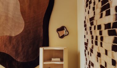 a showroom with neutral rugs on the wall, curvy furniture, and a mirrored and carpeted floor