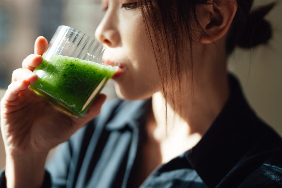 Close-up of young Asian woman drinking healthy detox for a healthy living close up of young asian woman drinking healthy detox for a healthy living