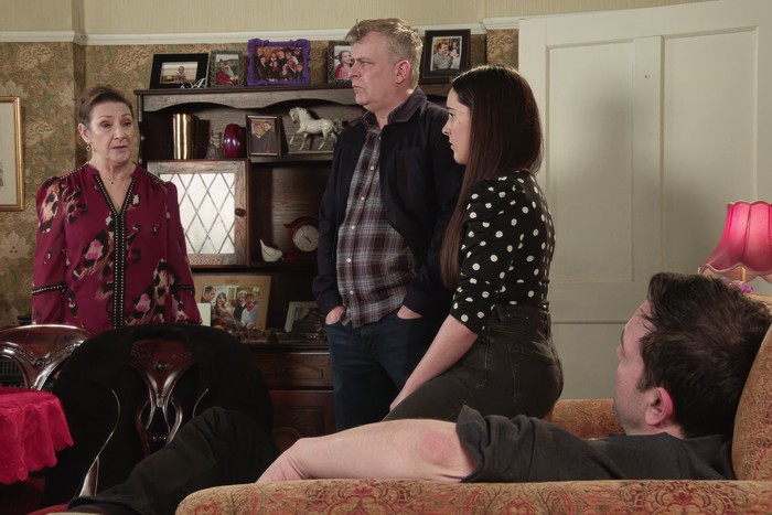 corrie-maggie-steve-amy-ben Maggie looking caught out as Steve and Amy stand next to her and Ben sits nearby in Coronation Street