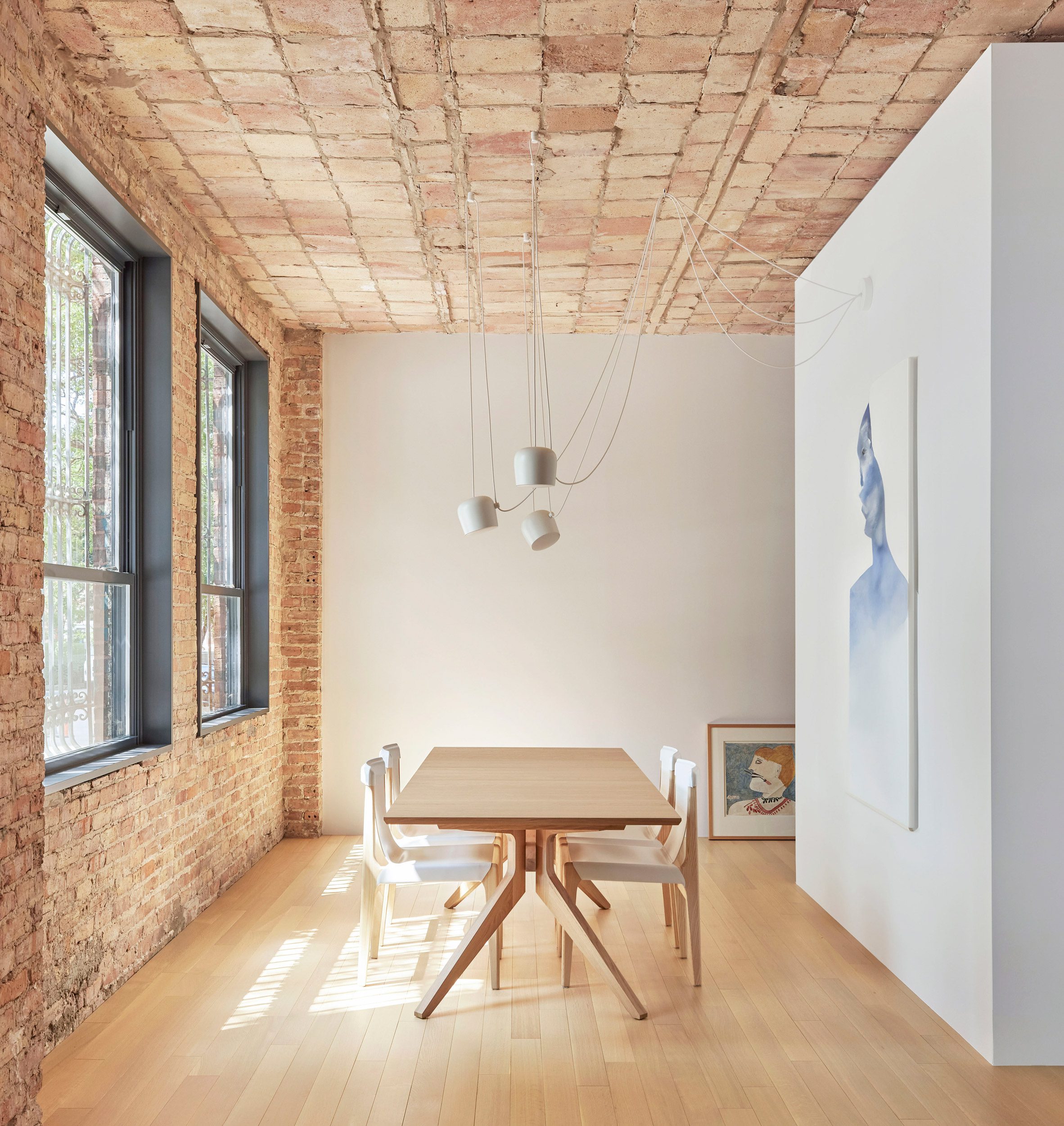 Dining room with a exposed clay tile ceiling and brick wall