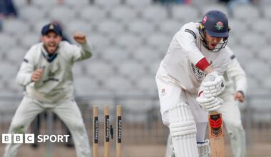 The bails are off as Luke Wells is bowled with a Derbyshire fielder celebrating in the background