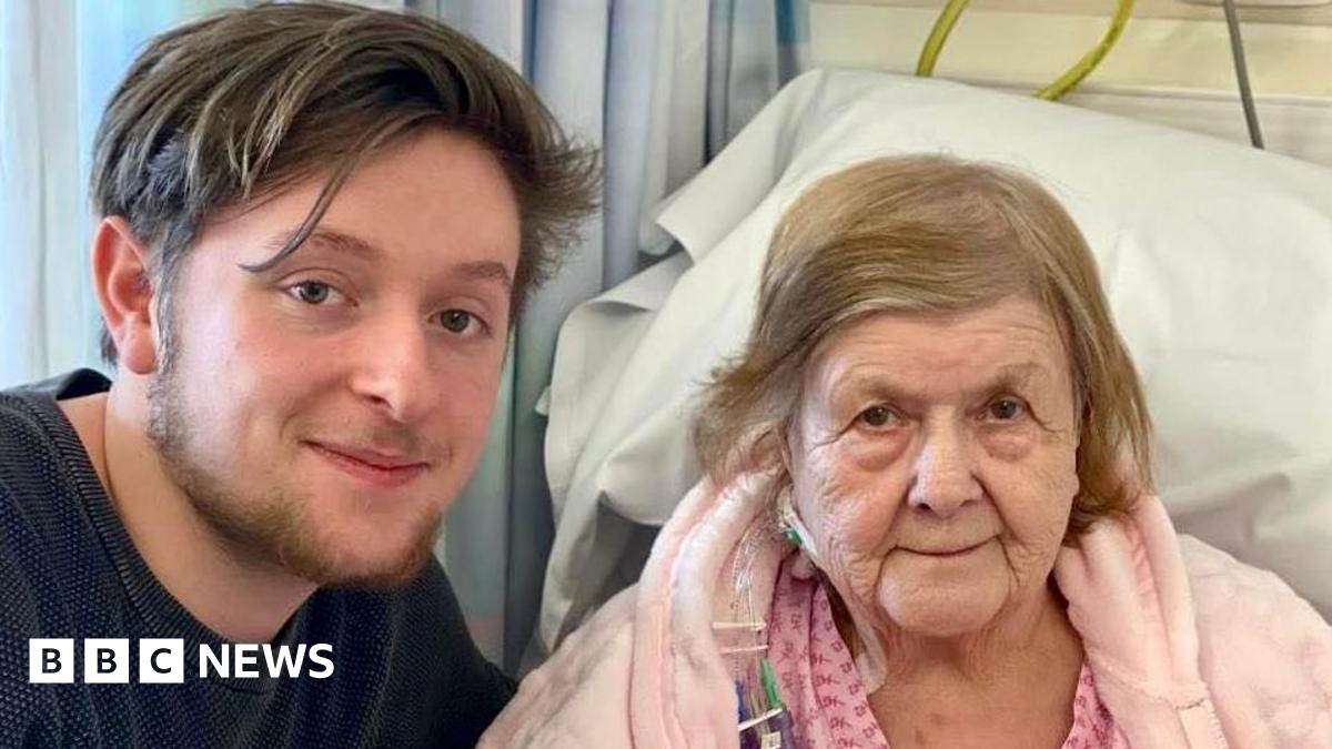 Tristan Essex on the left next to Jessie Stockdale who is in a hospital bed wearing a pink dressing gown.