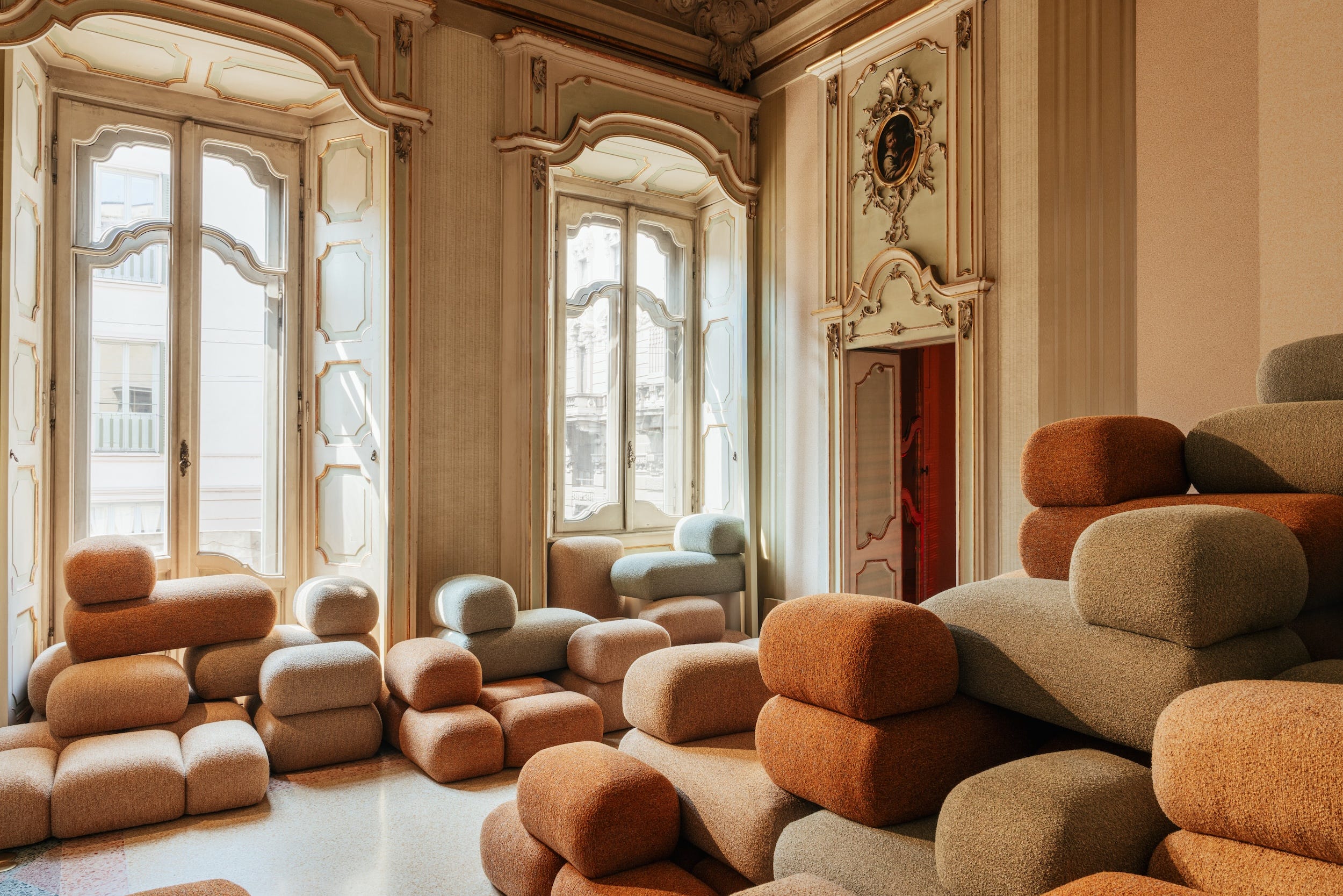 interior space featuring stacked textured seating elements and large windows