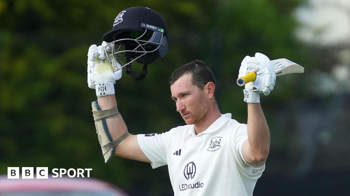 James Bracey raises the bat after his century for Gloucestershire against Lancashire