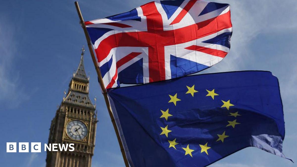 A Union Jack and European Union flag fly against a blue sky in front of Big Ben in central London.