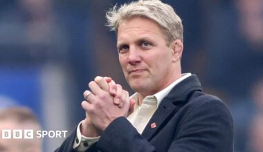 Lewis Moody smiles while clasping his hands