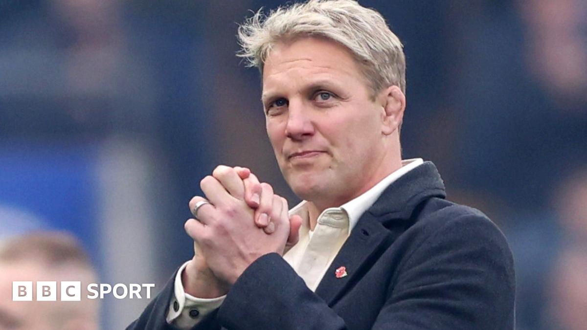 Lewis Moody smiles while clasping his hands