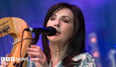 Shows Enya and other mourners at the funeral