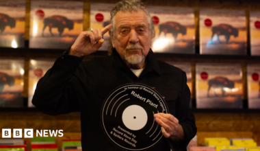Robert Plant signs a copy of his album "Saving Grace" in Cardiff's Spillers Records