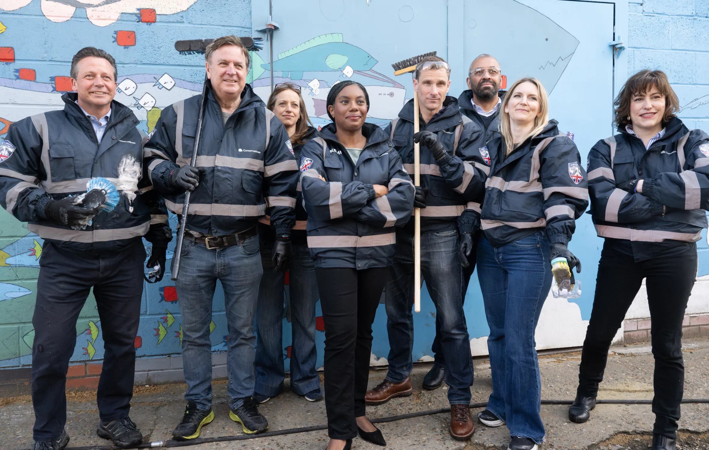 Kemi Badenoch MP and other MPs cleaning graffiti from walls in Herne Hill.