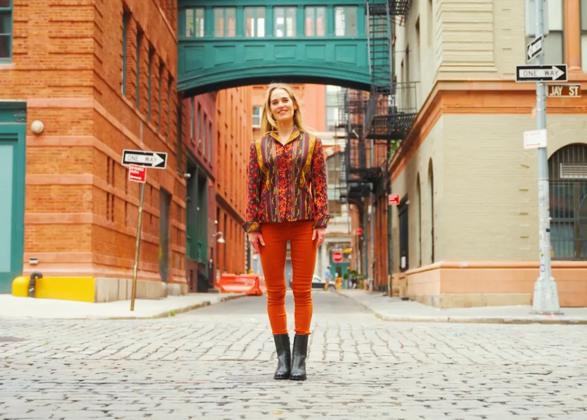 Willow Kemp standing on a cobblestone street.