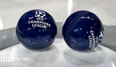 Two dark blue draw balls with the Uefa Champions League logo