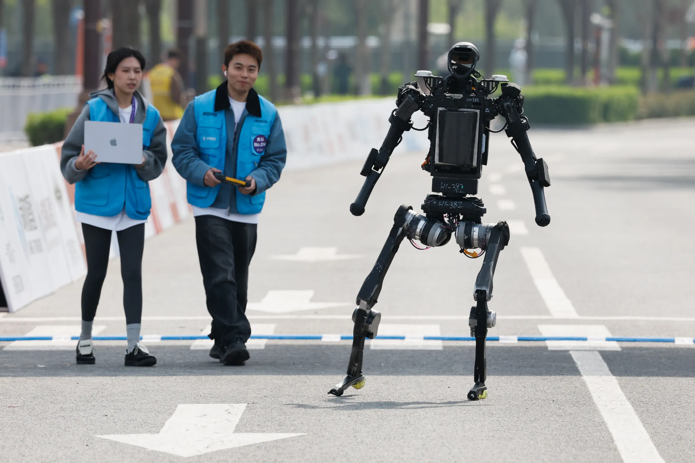 A humanoid robot crosses the finish line during the Beijing Humanoid Half Marathon.