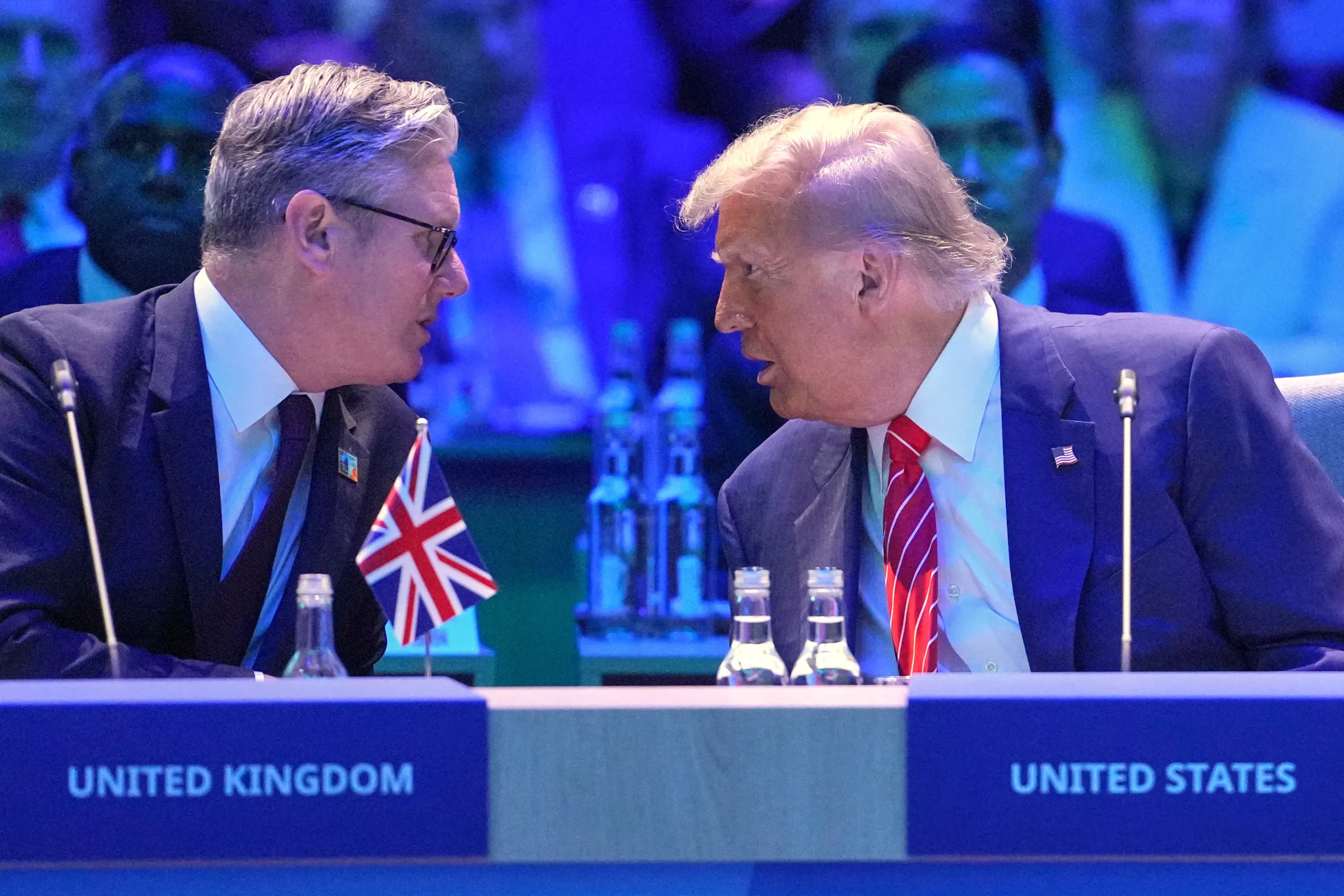 Donald Trump speaking with Keir Starmer at a NATO summit.