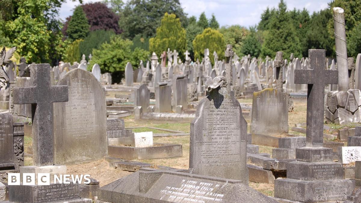 A wide shot of many graves in a cemetery.