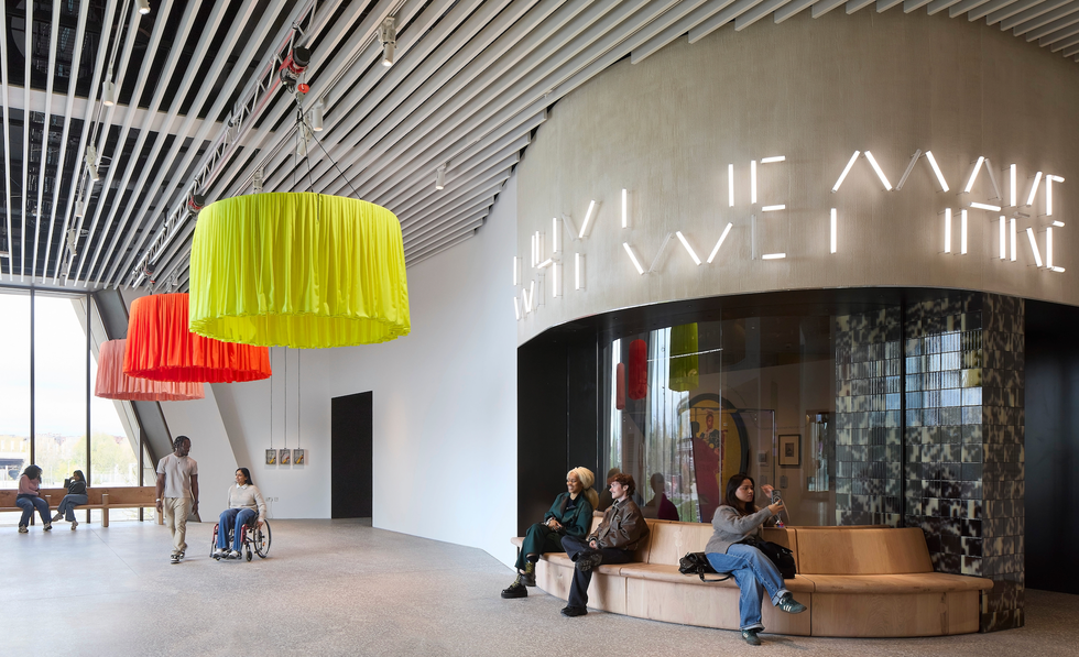 Interior of a contemporary space with colorful lighting fixtures and seating.