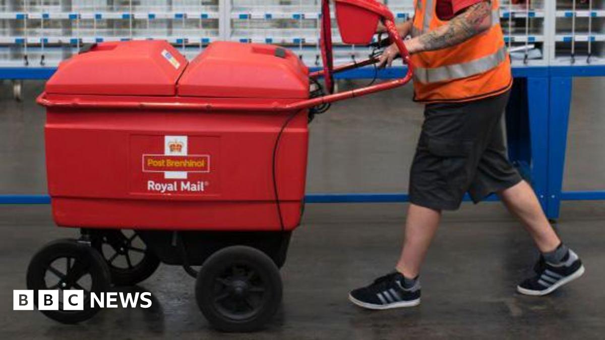 A worker pushes a trolley at the Royal Mail sorting office on Penarth Road on May 15, 2017 in Cardiff, United Kingdom