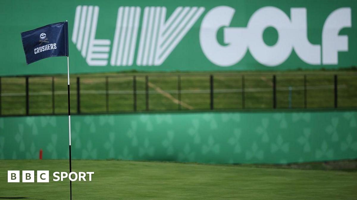 A flag on a golf course green in front of a sign that says 'LIV Golf'