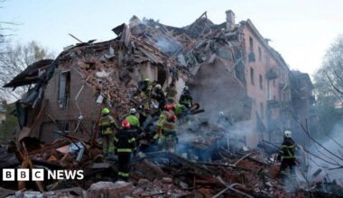 Rescue workers searching the ruins of a collapsed building in Ukraine
