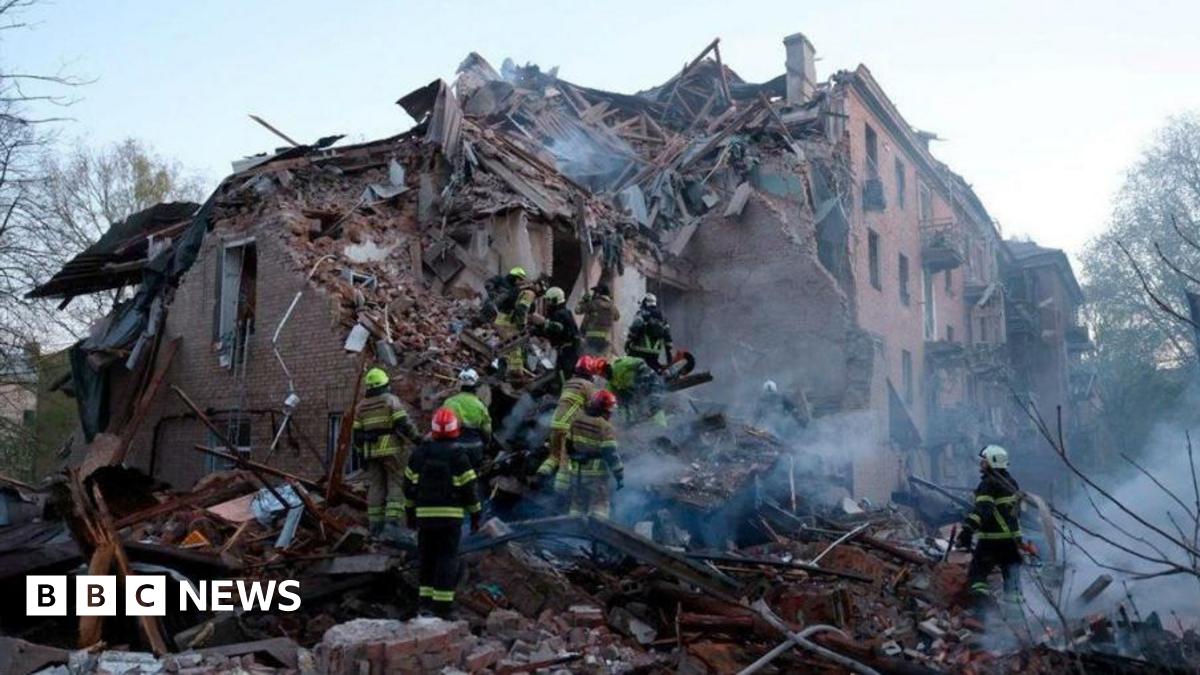 Rescue workers searching the ruins of a collapsed building in Ukraine