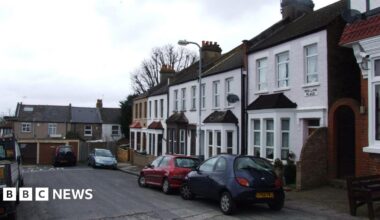 Red Lion Place, a cul-de-sac with about six houses, a garage and some parked cars