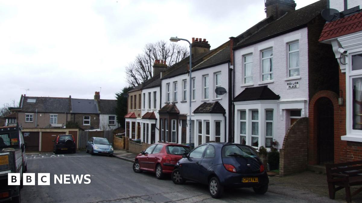 Red Lion Place, a cul-de-sac with about six houses, a garage and some parked cars