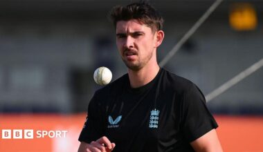 Josh Tongue throws himself a catch before bowling in a warm-up session for England