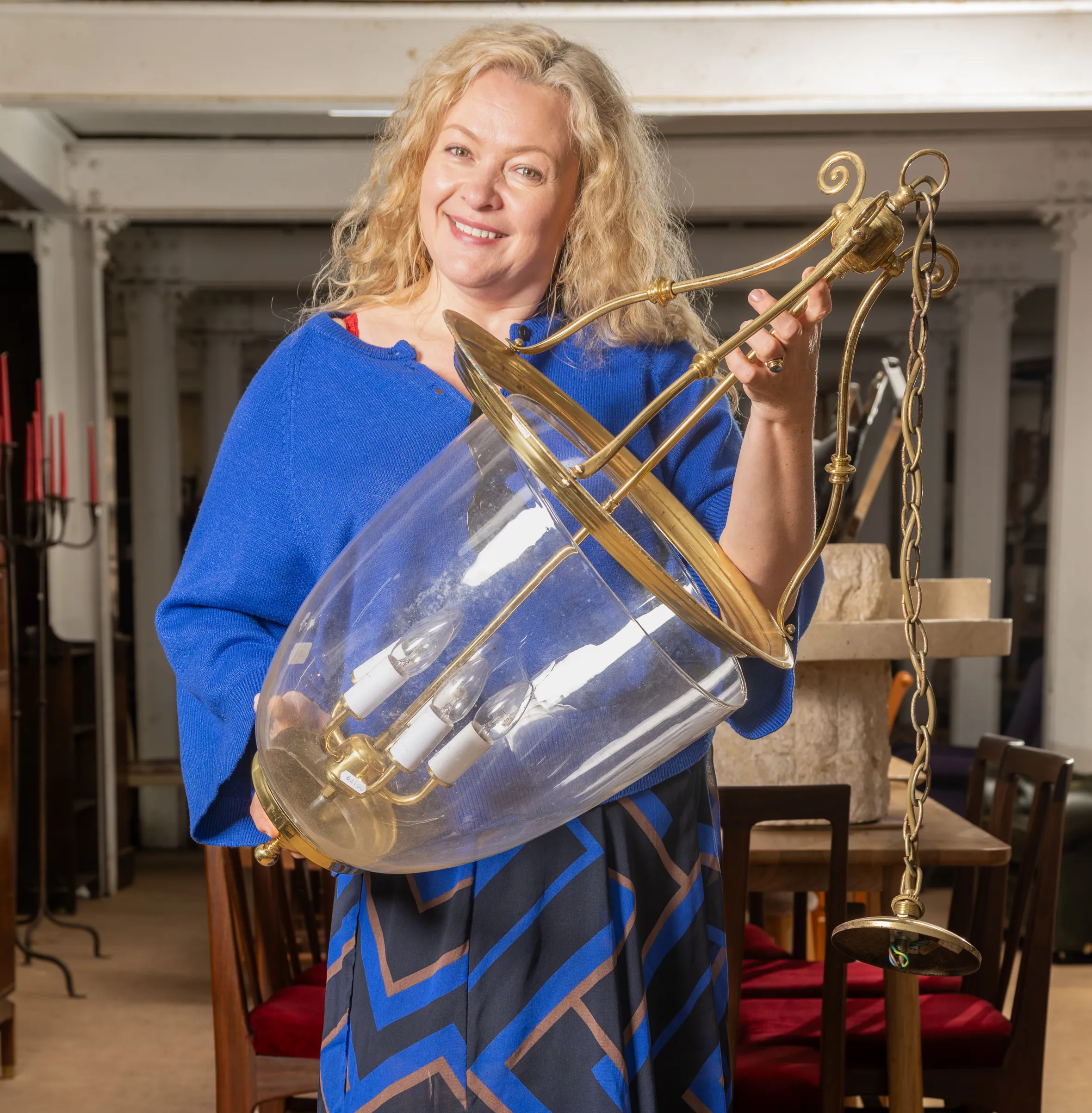 Helen Gente holding a purchased ceiling light.