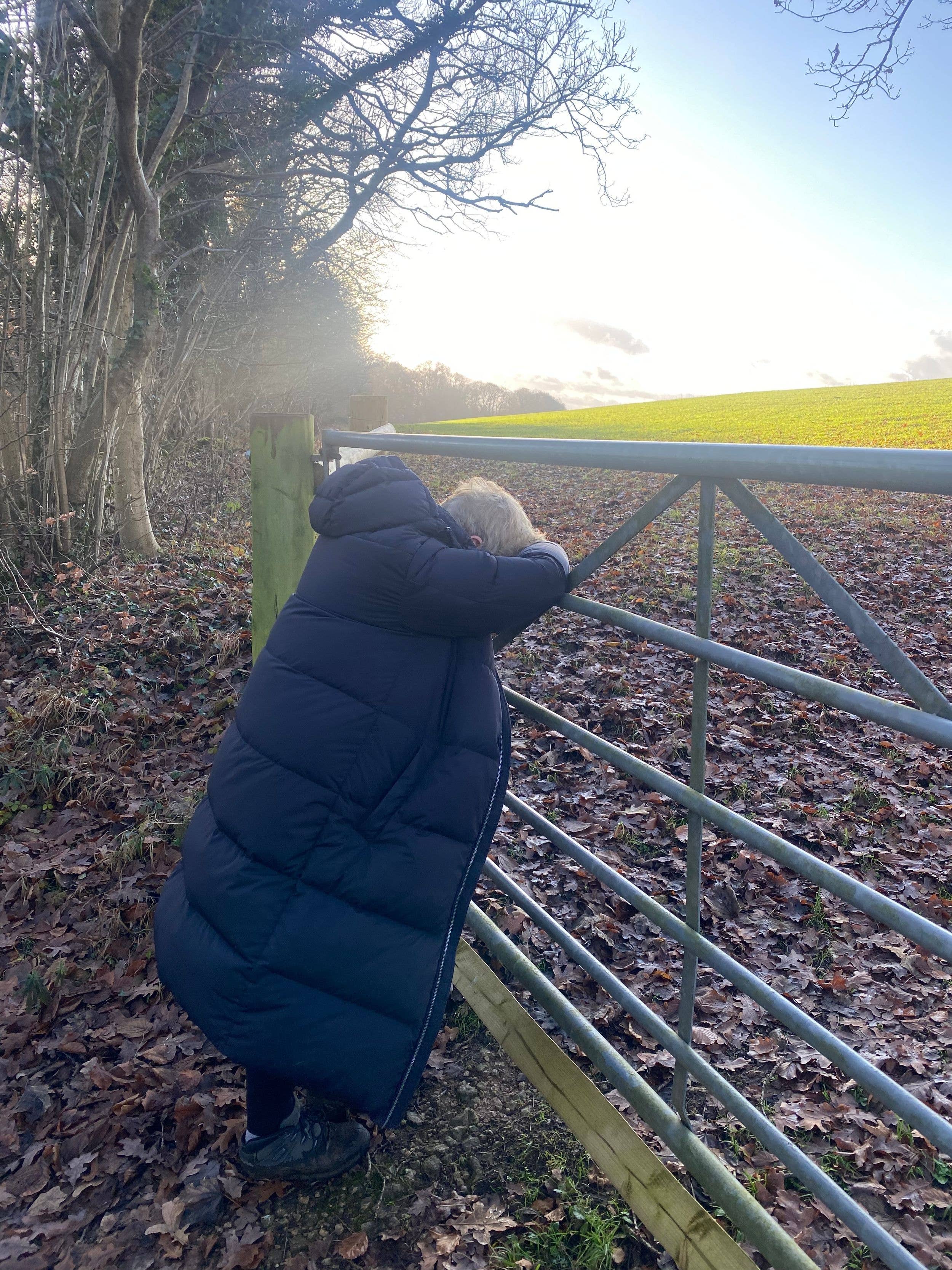 woman leaning on a gate during a walk 