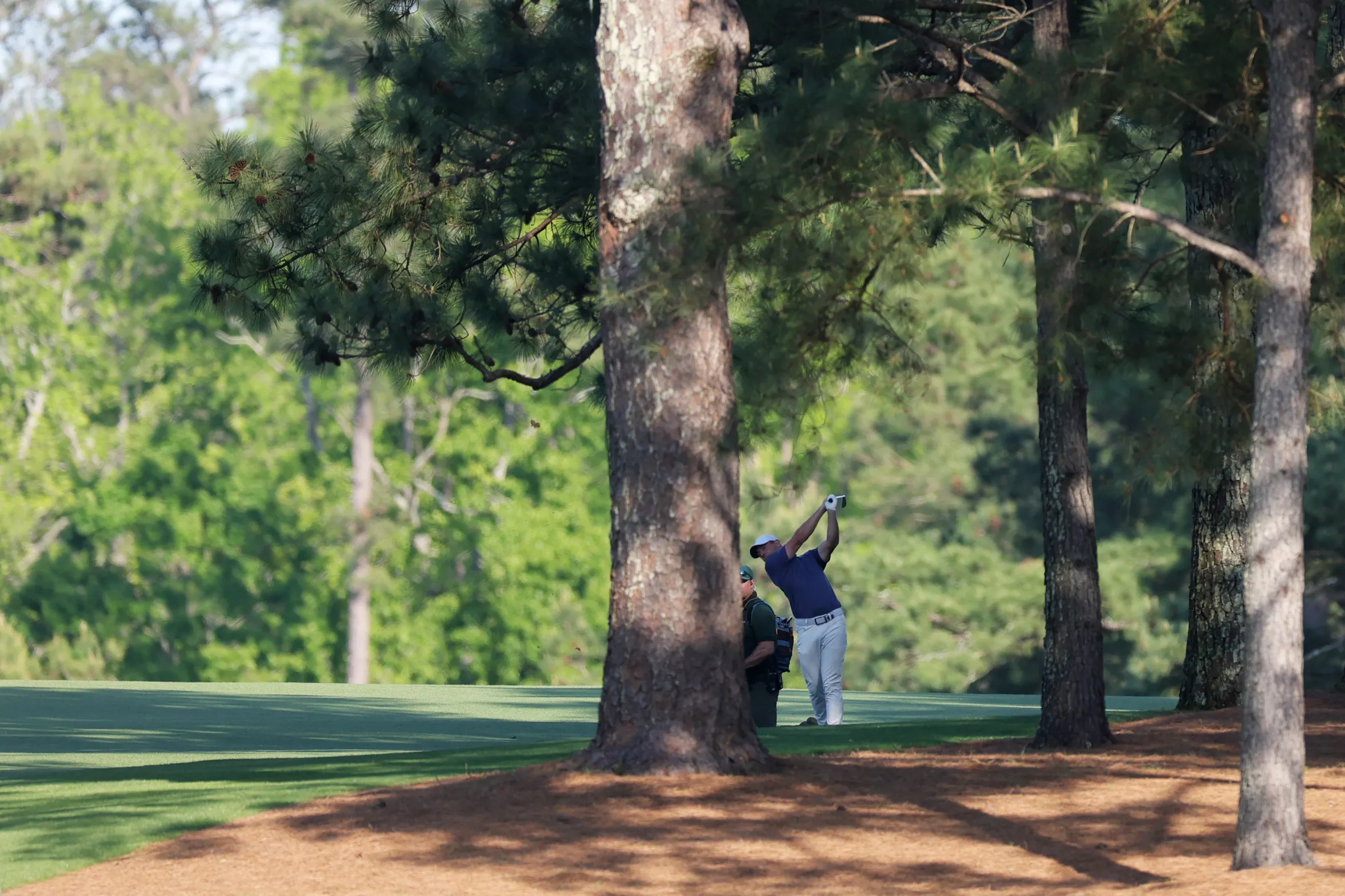 Rory McIlroy plays his second shot on the 15th hole at the Masters Tournament.