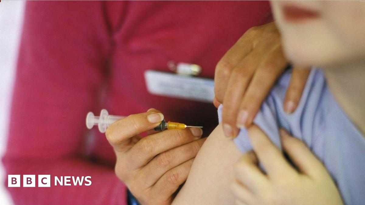 A close-up image of a person about to have a needle placed into their arm.