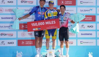 Sente Sentjens, Tom Crabbe and Cesar Mucias stand on the podium smiling and holding flowers at the finish of a stage of the Tour of Turkey
