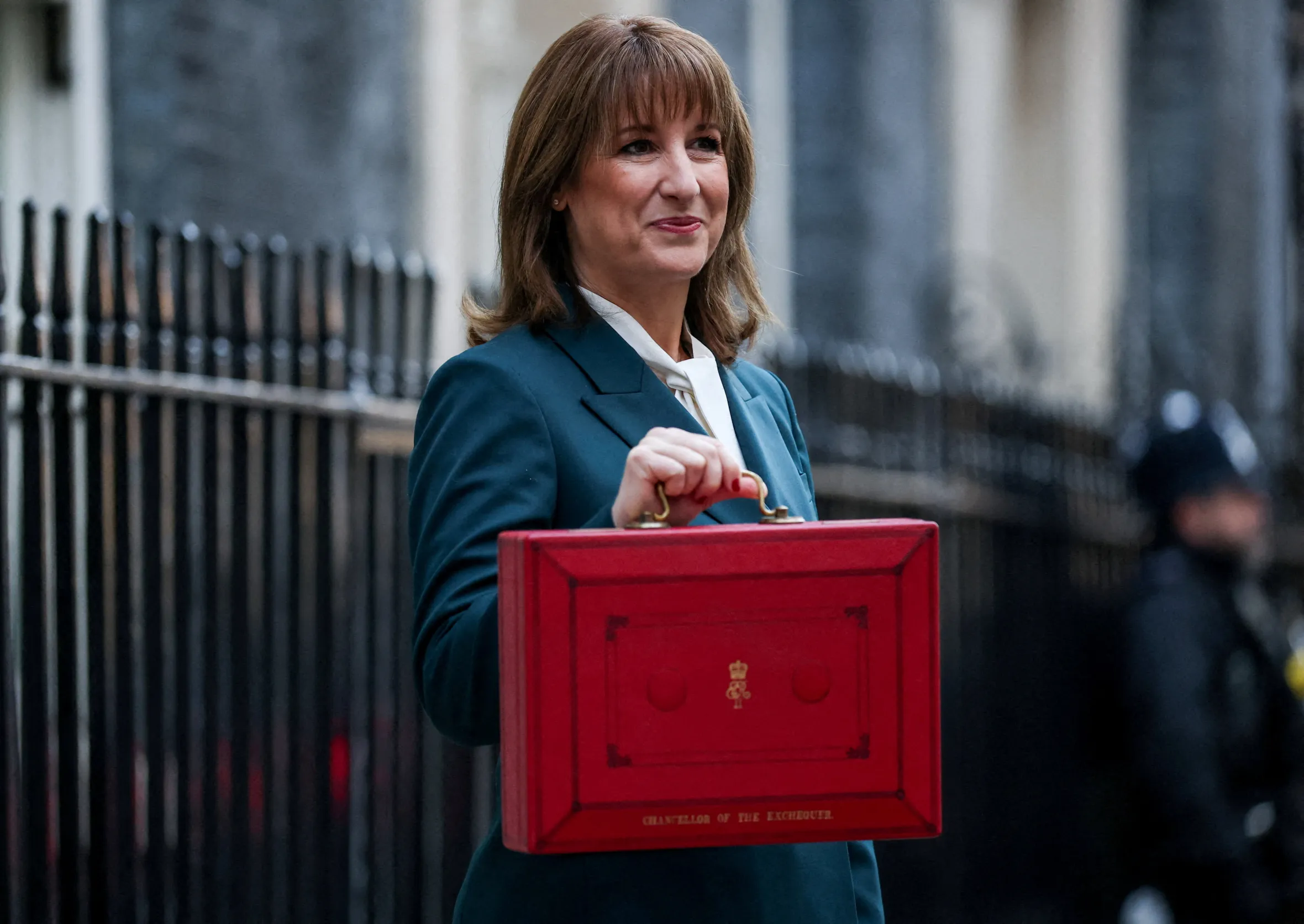 British Chancellor of the Exchequer Rachel Reeves holds the red budget box outside her office.