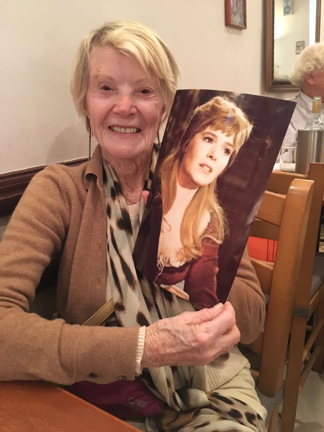 Shani Wallis holding a picture of herself from the film "Oliver"