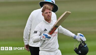 Kyle Verreynne raises his bat towards the Notts dressing room after scoring a century