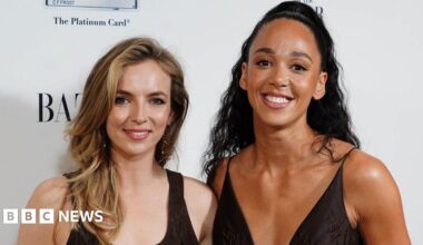 Jodie Comer and Katarina Johnson-Thompson pictured together at an awards ceremony where they are both wearing black dresses and smiling at the camera