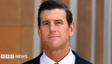 Ben Roberts-Smith looks at the camera, wearing a suit
