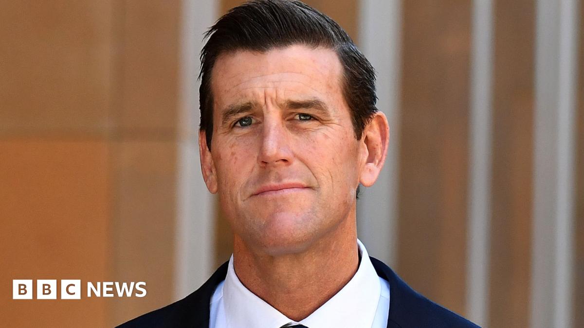 Ben Roberts-Smith looks at the camera, wearing a suit