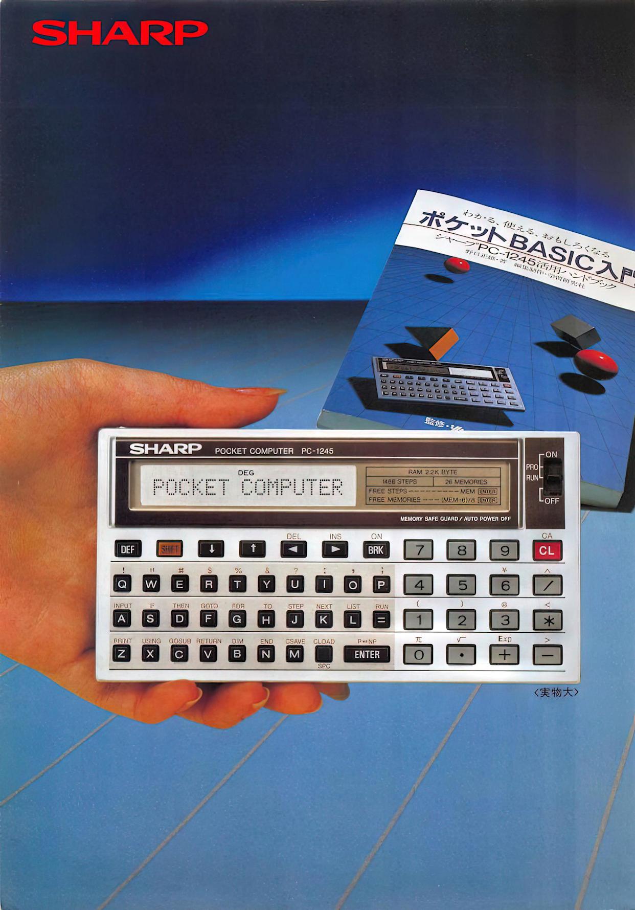 A hand holds a Sharp Pocket Computer PC-1245 displaying "POCKET COMPUTER" on its screen. In the background is the device's box with Japanese text, a pen, and geometric shapes on a blue tiled surface.